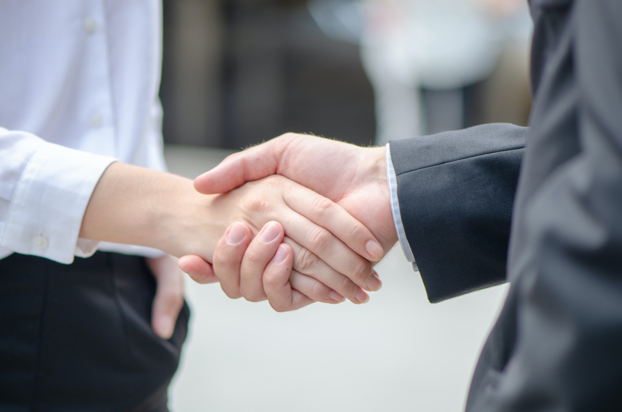 Business people shake hands to agree partnership and have faith it business success